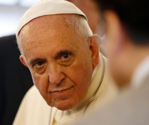 Pope Francis listens to a journalist's question on the flight back to Rome. (CNS/Paul Haring)